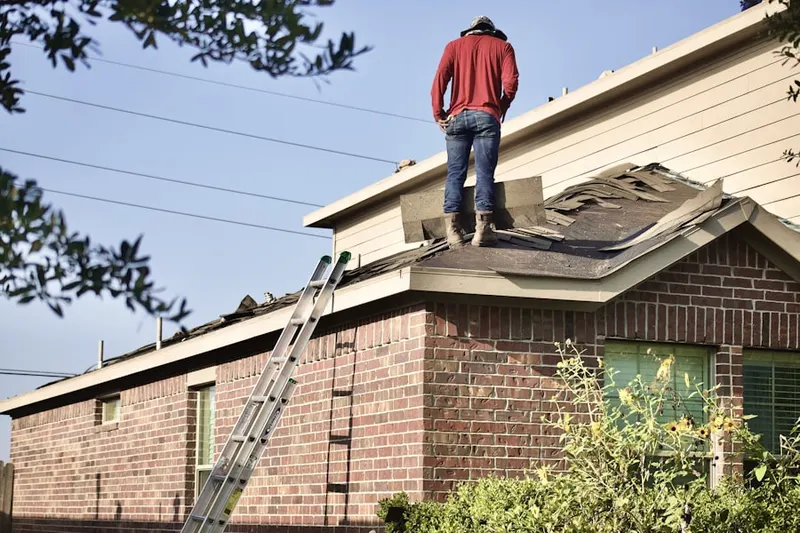 Professional roofer working on a residential roof in Roundtree Estates
